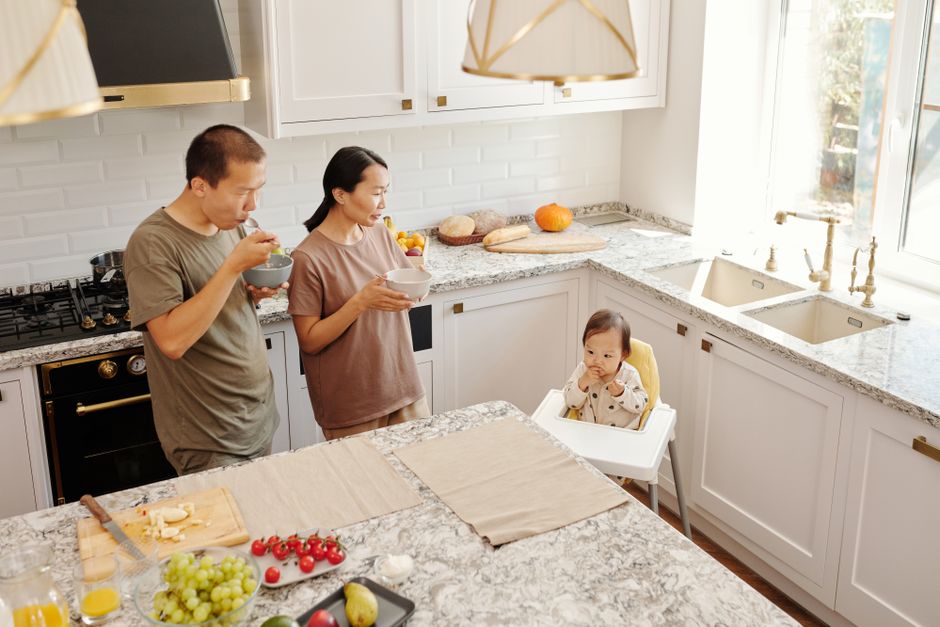 Family kitchen with a countertop and a high chair at the table.